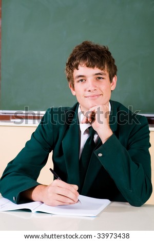 Portrait of a smart male high school student in classroom