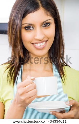 young beautiful woman drinking coffee in kitchen
