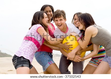 stock photo group of teens playing beach ball