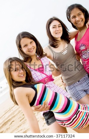stock photo four close teen friends on beach