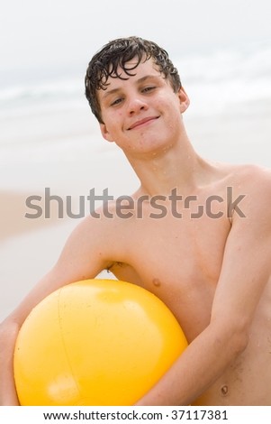 stock photo teen boy with yellow beach ball Save to a lightbox 