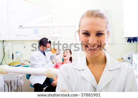 friendly female dentist in dental practice