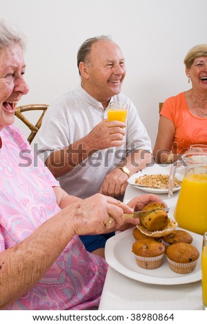happy senior friends having breakfast together