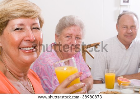 happy seniors friends having breakfast together