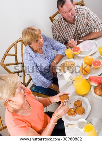 senior people having breakfast together