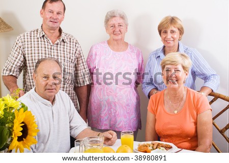 group of senior friends at breakfast table