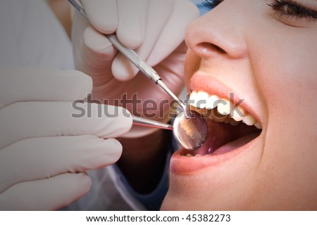 beautiful young woman visiting dentist for dental checkup