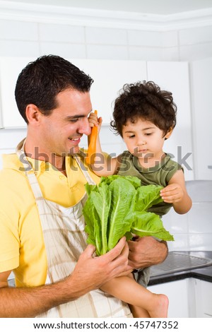 young dad and baby boy in kitchen