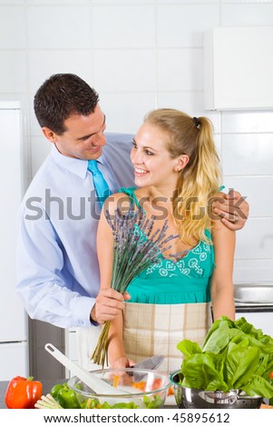 young husband coming home with flower to give to his hardworking wife