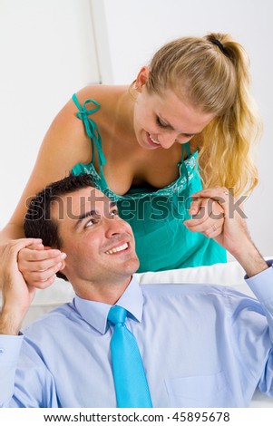 Portrait of a happy woman covering her boyfriend's eyes to surprise him