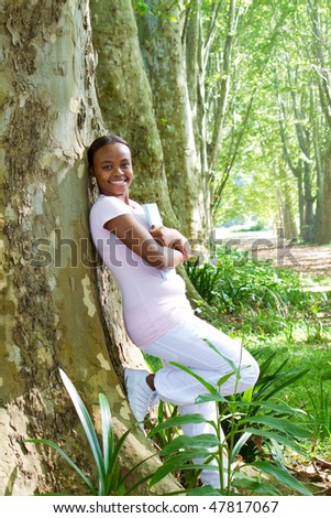 female african american college student in forest