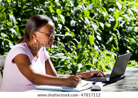 female African American student studying outdoors