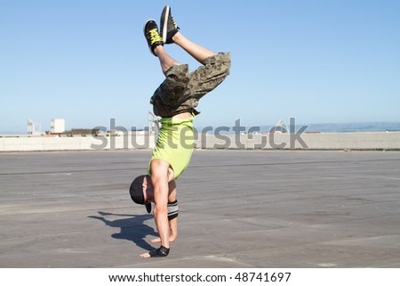 young male hip hop dancing outdoors