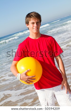 stock photo teen boy with beach ball on beach