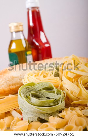 raw pasta, bread, olive oil and tomato sauce