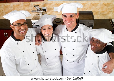 group of professional chefs in commercial kitchen