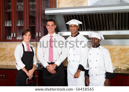 restaurant staff inside industrial kitchen