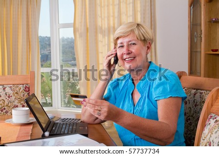 senior woman buying online and paying with credit card