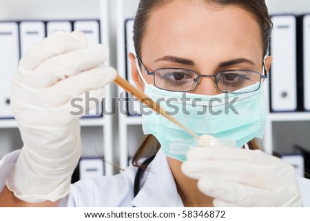 young female lab technician conducting science researching