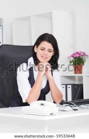 Business woman in eager waiting for a phone call in office (focus on phone)