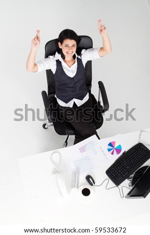 overhead view of beautiful businesswoman crossing finger for good luck