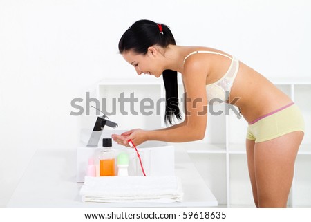 stock-photo-young-woman-washing-up-in-bathroom-59618635.jpg