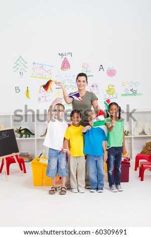 group of preschool kids and teacher with flags in classroom