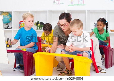 preschool students and female teacher in kindergarten