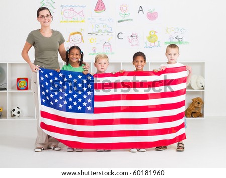 American preschool students and teacher holding a USA flag