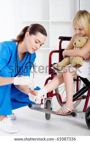caring nurse bandage little girl\'s ankle