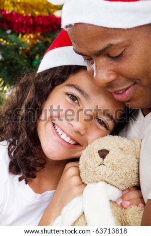 happy daughter hugging daddy with Christmas gift