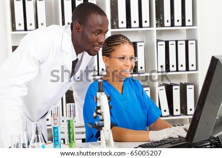 two african american scientists working in lab together