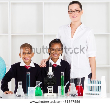 portrait of primary teacher and students in science class