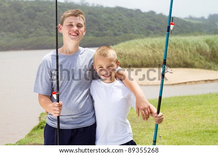 two little brothers fishing by the lake