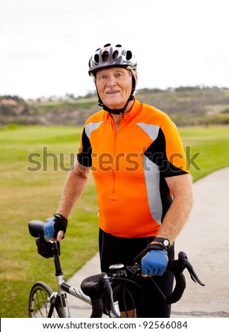 senior professional male cyclist with his road bike