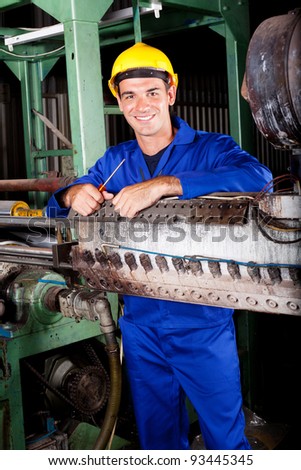 happy industrial mechanic in heavy industry plant