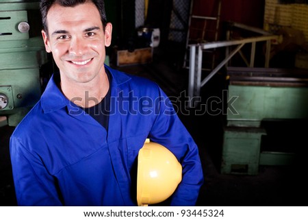 happy blue collar worker portrait in factory