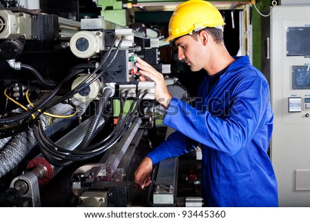 male caucasian operator operating industrial printing press