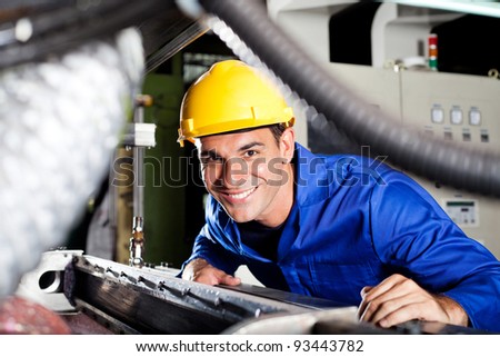 happy modern blue collar worker in factory