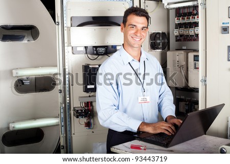 portrait of professional industrial technician in front of machinery