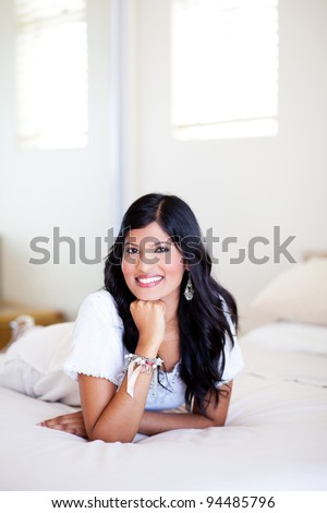 beautiful young hispanic woman portrait on bed