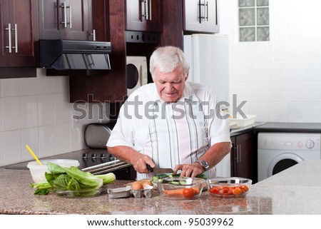 elderly man cooking in home kitchen