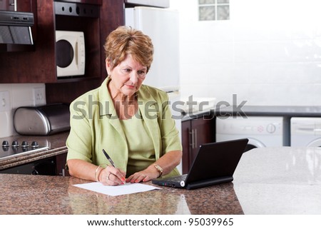 senior woman doing home finance and looks worried