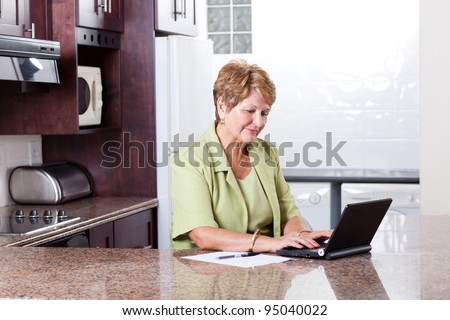 senior woman using internet banking at home