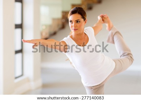 pretty woman doing yoga pose at home