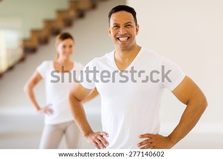 happy middle aged man standing in front wife after exercise at home