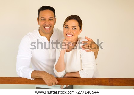 portrait of middle aged couple inside their new house
