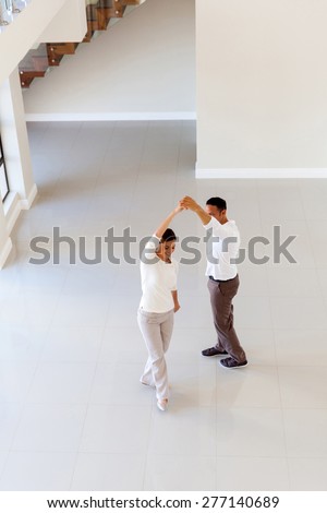 overhead view of couple dancing at their new home