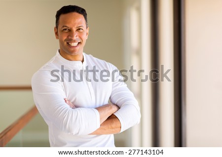 portrait of happy middle ages man with arms folded