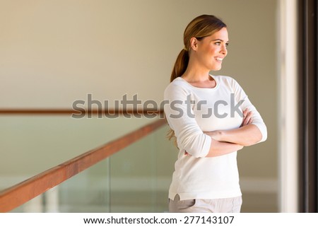 attractive young woman looking outside window